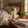Touch LED table lamp glowing softly on a bedroom side table